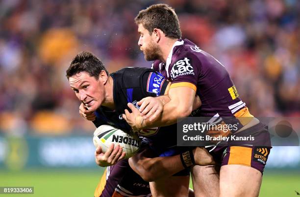 Josh Jackson of the Bulldogs is tackled during the round 20 NRL match between the Brisbane Broncos and the Canterbury Bulldogs at Suncorp Stadium on...