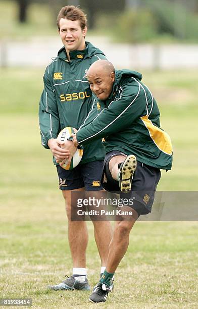 Bolla Conradie of the Springboks practices kicking as team mate Peter Grant looks on during a South African Springboks training session at Colins...