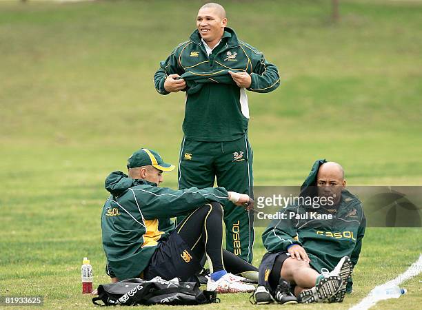 Conrad Jantjes, Ricky Januarie, Bolla Conradie of the Springboks relax after a South African Springboks training session at Colins Oval on July 15,...