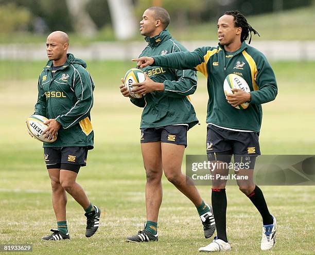 Odwa Ndungane of the Springboks gestures to team mates while walking with team mates JP Pietersen and Bolla Conradie during a South African...