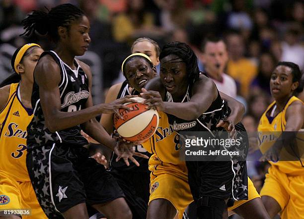 Sophia Young and Morenike Atunrase of the San Antonio Silver Stars vie for posession against DeLisha Milton-Jones of the Los Angeles Sparks during...