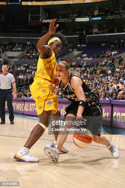 Becky Hammon of the San Antonio Silver Stars dribbles against Marie Ferdinand-Harris of the Los Angeles Sparks during their game on July 14, 2008 at...