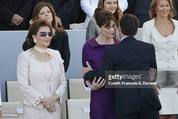 French President Nicolas Sarkozy kisses his wife Carla Bruni-Sarkozy prior to the start of the ceremony of the Bastille Day, on July 14, 2008 in...