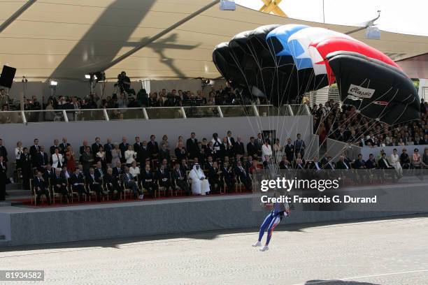 Paratrooper prepares to land in the Champs Elysees in front of heads of State and government during the Bastille Day military parade on the Champs...