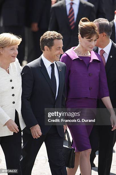 French President Nicolas Sarkozy and wife Carla Bruni-Sarkozy leave the ceremony of Bastille Day with German chancellor Angela Merkel , on July 14,...