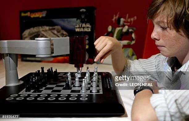 Boy plays against the "2 Robot" robotic chess game at the Hamleys Christmas toy photocall in London, on July 15, 2008. Hamleys unveiled on Tuesday...