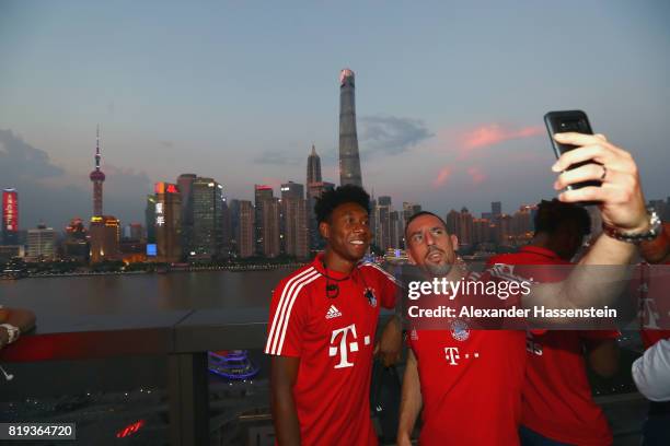 Franck Ribery of FC Bayern Muenchen takes a selfie with his team mate David Alaba and the Shanghai Bund during the Audi Night 2017 at Wanda Reign...