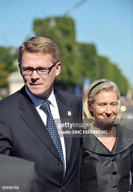 Finnish Prime minister Matti Vanhanen and his companion Sirkka Mertala are seen during celebrations for the Bastille Day on July 14, 2008 in Paris....