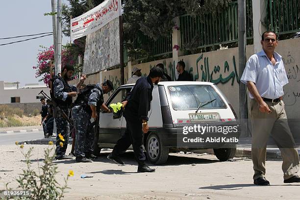 Palestinian security men, loyal to Hamas, check a car in the area which was supposed to be visited by the envoy of Quartet of International Mediators...