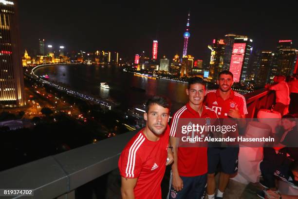 Juan Bernat of FC Bayern Muenchen poses with , James Rodriguez and Javier Martinez for a picture with the Shanghai Bund in the background during the...