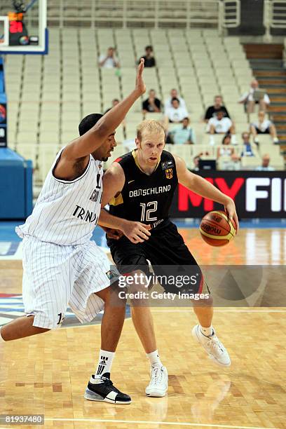 Chris Kaman of Germany dribbls the ball against Pedro Cipriano of Cape Verde during the Fiba Olympic Qualifier match between Cape Verde and Germany...