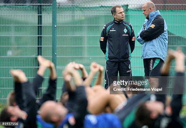 Coach Thomas Schaaf speaks with Dr. Goetz Dimanski during the Training Camp of Werder Bremen at the 'Sportplatz an der Muehle' on July 15, 2008 in...