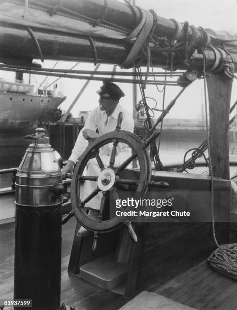American actor John Barrymore at the wheel of his yacht 'Infanta', circa 1930.