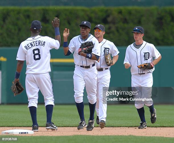 Edgar Renteria, Curtis Granderson, Ryan Raburn, and Brent Clevlen of the Detroit Tigers high-five during the game against the Cleveland Indians at...