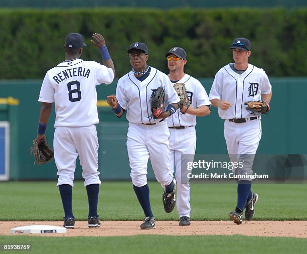 Edgar Renteria, Curtis Granderson, Ryan Raburn, and Brent Clevlen of the Detroit Tigers high-five during the game against the Cleveland Indians at...