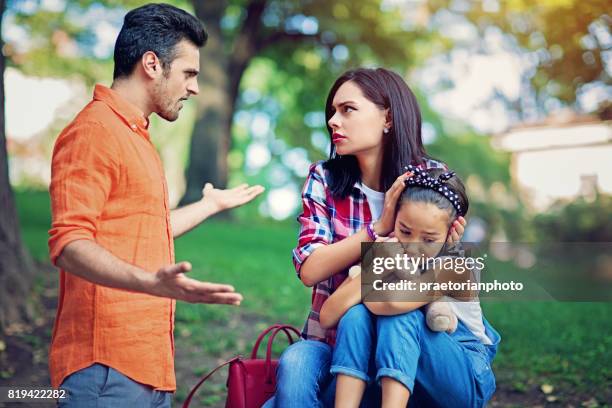 husband is arguing with wife at the front of their little daughter - family violence stock pictures, royalty-free photos & images