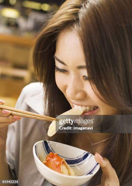 woman eating japanese style chowder - woman eating crab stock pictures, royalty-free photos & images