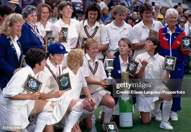 Karen Smithies, captain of the England women's cricket team holds the trophy surrounded by her teammates after England defeated New Zealand by 67...