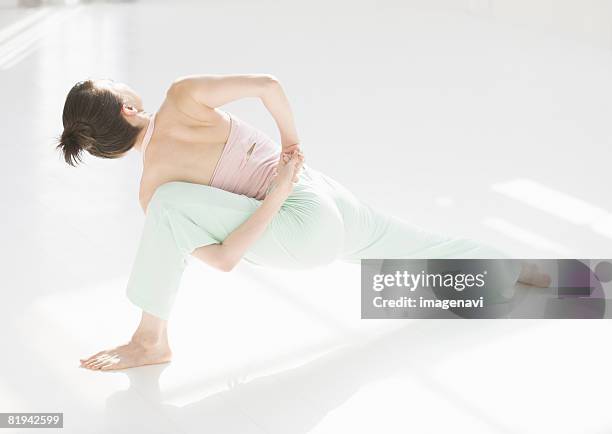 woman doing yoga - woman jogging pants stock pictures, royalty-free photos & images