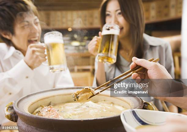 group of young people enjoying drinks - hot pot dish fotografías e imágenes de stock