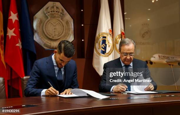 Dani Ceballos of Real Madrid signs his contract beside President Florentino Perez during his official presentation at Estadio Santiago Bernabeu on...