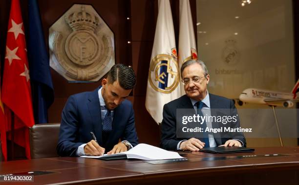 Dani Ceballos of Real Madrid signs his contract beside President Florentino Perez during his official presentation at Estadio Santiago Bernabeu on...