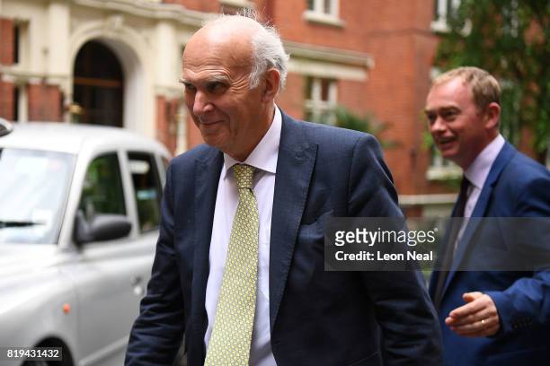 New Liberal Democrats leader Vince Cable passes former leader Tim Farron as he arrives arrives at the St Ermin's Hotel on July 20, 2017 in London,...