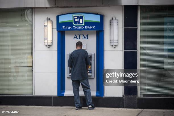 Customer uses a Fifth Third Bancorp automatic teller machine outside a bank branch in Chicago, Illinois, U.S., on Thursday, July 13, 2017. Fifth...