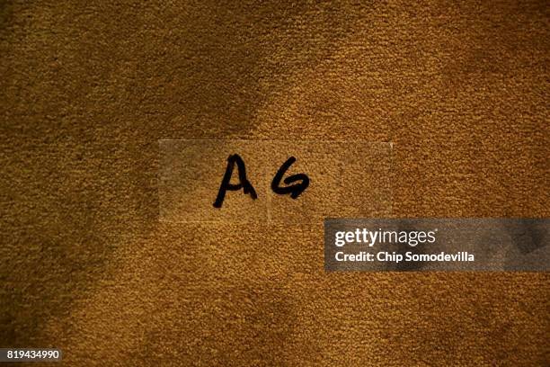 Tape marks the place where U.S. Attorney General Jeff Sessions is to stand during a news conference to announce an 'international cybercrime...