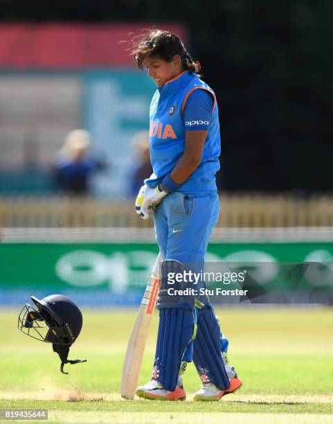 India batsman Harmanpreet Kaur reacts by throwing her helmet off onto the ground after reaching her century during the ICC Women's World Cup 2017...