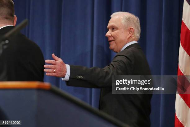 Attorney General Jeff Sessions leaves a news conference to announce an 'international cybercrime enforcement action' at the Department of Justice...