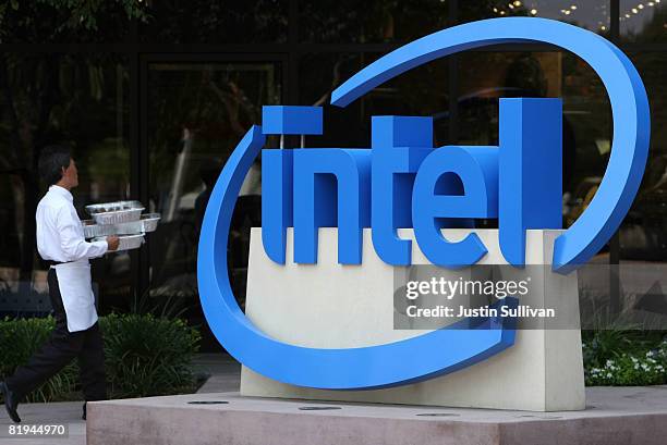 An caterer carries trays of food by a sign at the Intel company headquarters July 15, 2008 in Santa Clara, California. Intel has reported a 25...
