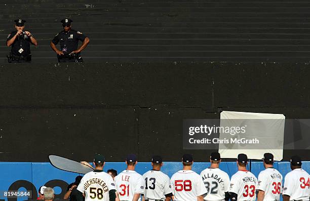 New York City police officer takes a picture of the American League All-Star team before the 79th MLB All-Star Game at Yankee Stadium on July 15,...