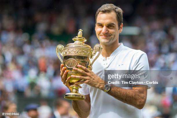Roger Federer of Switzerland celebrates victory with the trophy after the Gentlemen's Singles final of the Wimbledon Lawn Tennis Championships at the...