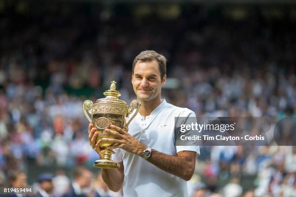 Roger Federer of Switzerland celebrates victory with the trophy after the Gentlemen's Singles final of the Wimbledon Lawn Tennis Championships at the...