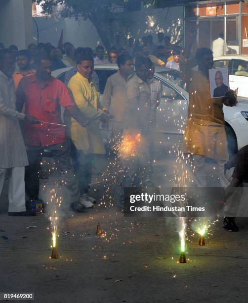 Workers celebrate at party office after NDA candidate Ram Nath Kovind was elected as 14th President of India on July 20, 2017 in Lucknow, India. NDA...