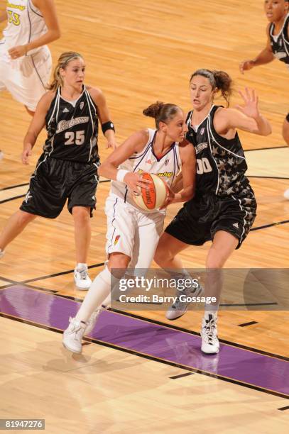 Diana Taurasi of the Phoenix Mercury drives against Ruth Riley of the San Antonio Silver Stars on July 15 at U.S. Airways Center in Phoenix, Arizona....