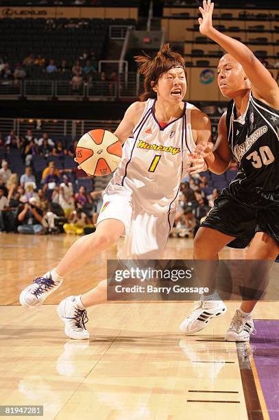 Yuko Oga of the Phoenix Mercury drives against Helen Darling of the San Antonio Silver Stars on July 15 at U.S. Airways Center in Phoenix, Arizona....