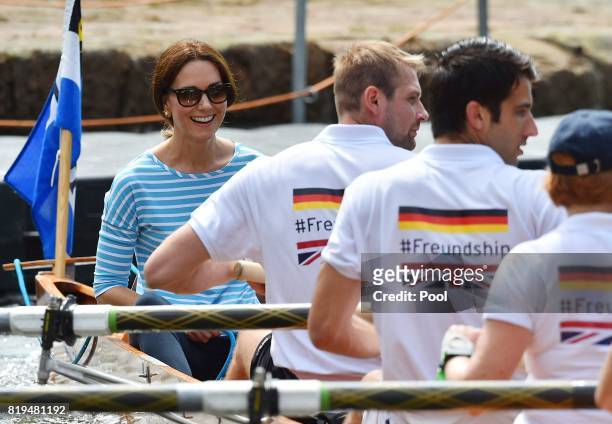 Catherine, Duchess of Cambridge competes against Prince William, Duke of Cambridge as they cox rowing boats in a friendly race between the twinned...
