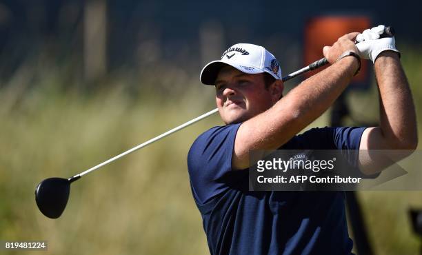 Golfer Patrick Reed watches his drive from the 6th tee during his opening round on the first day of the Open Golf Championship at Royal Birkdale golf...