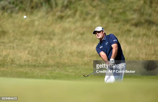 Golfer Patrick Reed chips onto the 6th green during his opening round on the first day of the Open Golf Championship at Royal Birkdale golf course...