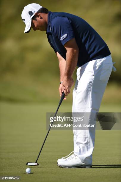 Golfer Patrick Reed putts on the 6th green during his opening round on the first day of the Open Golf Championship at Royal Birkdale golf course near...