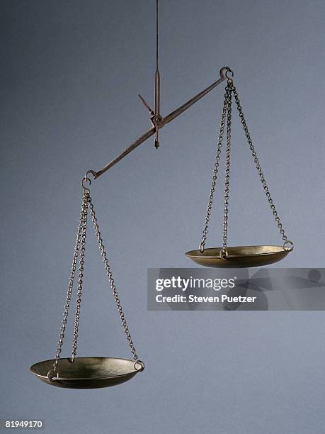 imbalanced weight scale against gray background - balansvåg bildbanksfoton och bilder
