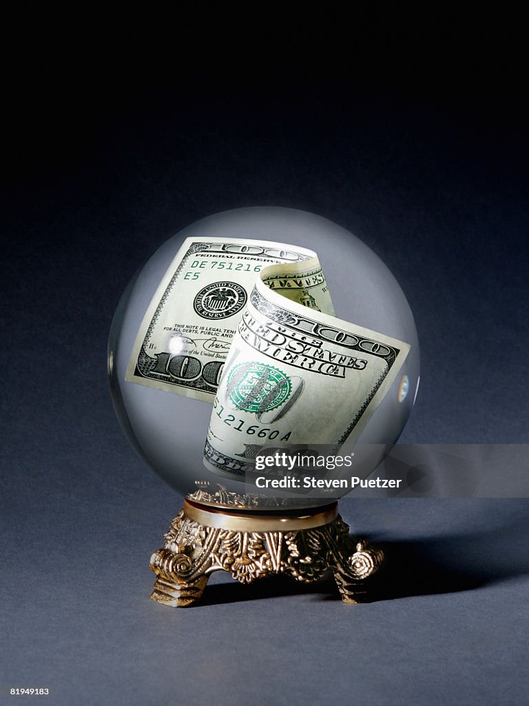 One hundred dollar bill in crystal ball