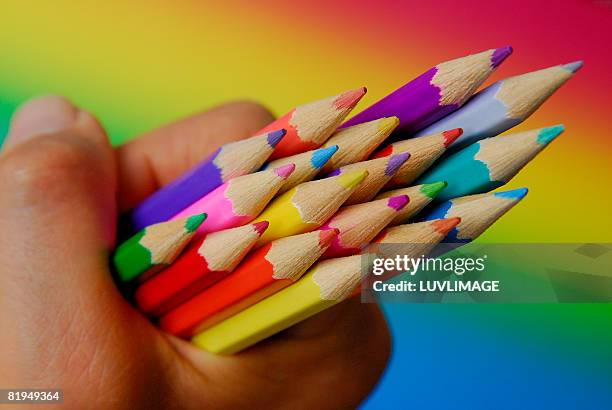 hand holding coloured pencils - colored pencils stock pictures, royalty-free photos & images