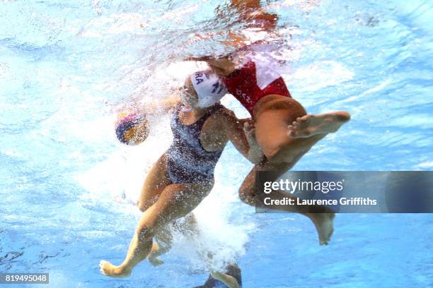 Mariana Duarte of Brazil is challenged during the Women's Water Polo Group A, preliminary round match between Brazil and Canada on day seven of the...