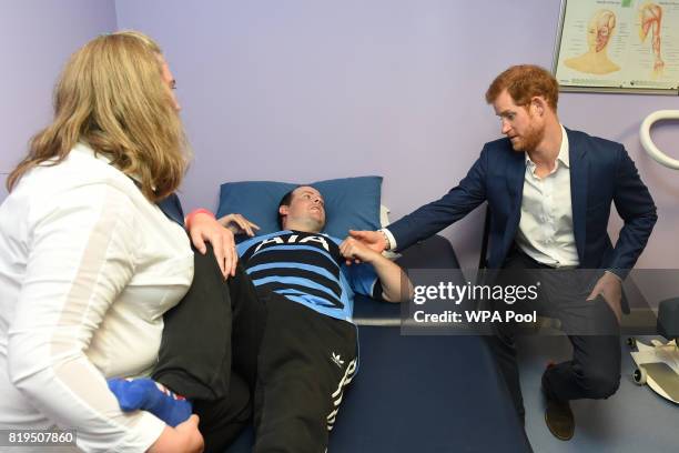 Prince Harry meets brain injury survivor Robbie Cannell as he undergoes physiotherapy during a visit to Headway, a Charity supporting brain injuries...