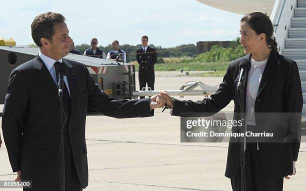 French President Nicolas Sarkozy holds the hand of Igrid Betancourt during the arrival ceremony at military base of villacoublay on July 4, 2008 in...