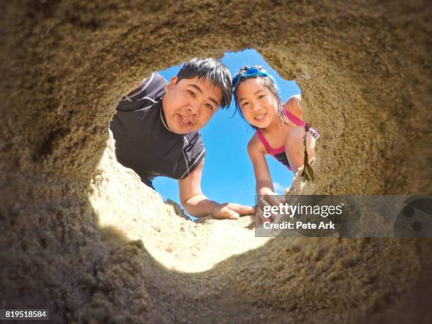 digging in the sand - peeping holes stock pictures, royalty-free photos & images