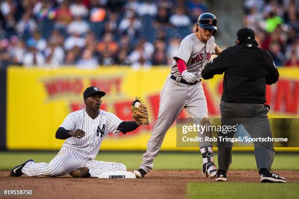 Josh Rutledge the Boston Red Sox slides safely before the tag by Didi Gregorius of the New York Yankees during the game against the New York Yankees...